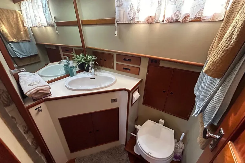 Radius Yacht Photos Pics Elegant 1986 Grand Banks 42 Classic yacht bathroom with sink, toilet, and wooden cabinetry.