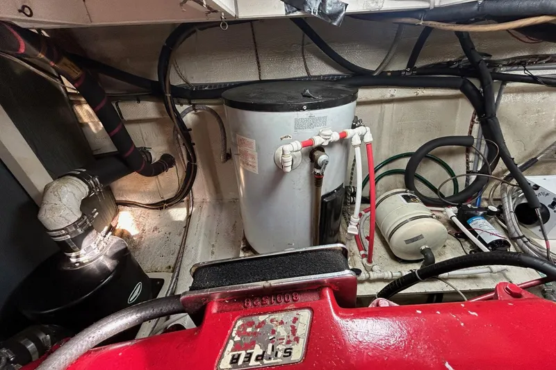 Radius Yacht Photos Pics Engine room of a 1986 Grand Banks 42 Classic with visible piping and equipment.