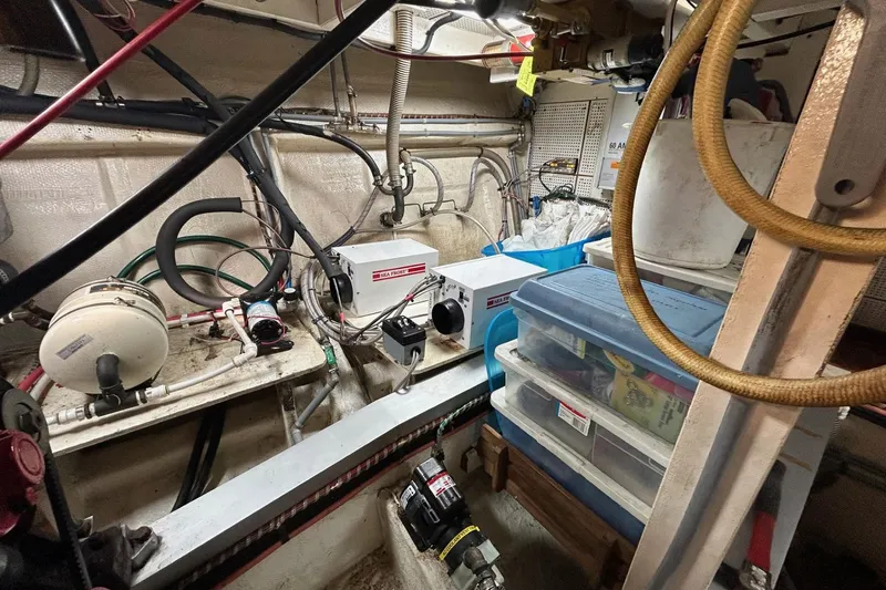 Radius Yacht Photos Pics Engine room of a 1986 Grand Banks 42 Classic with equipment and storage containers.