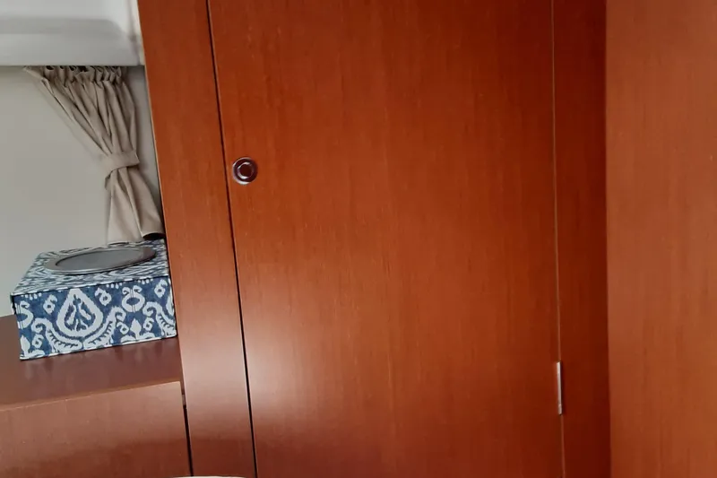  Yacht Photos Pics Interior of 2014 Beneteau Swift Trawler 34 with wooden cabinetry and decorative box.