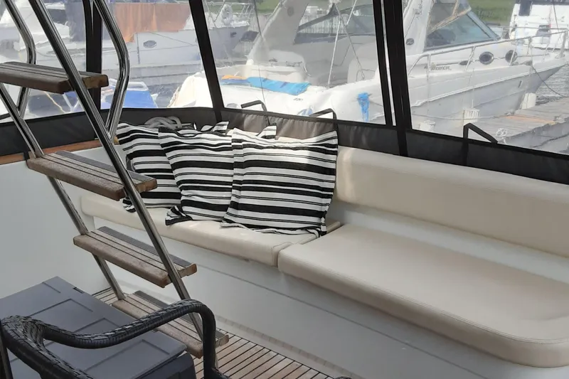  Yacht Photos Pics Interior of 2014 Beneteau Swift Trawler 34 with striped cushions and seating area.