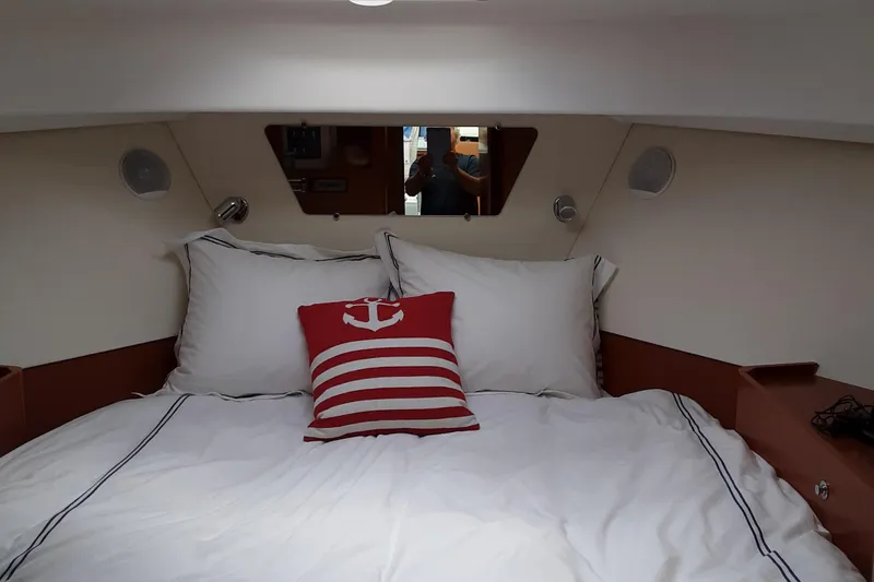  Yacht Photos Pics Cozy bedroom in 2014 Beneteau Swift Trawler 34 with nautical-themed decor.