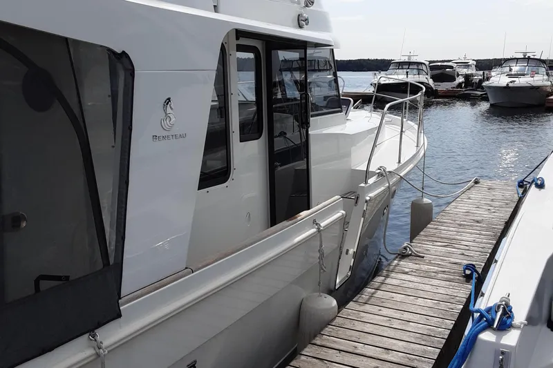  Yacht Photos Pics 2014 Beneteau Swift Trawler 34 docked at marina, side view.