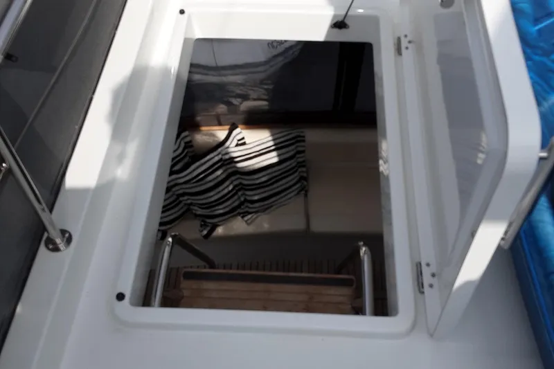  Yacht Photos Pics 2014 Beneteau Swift Trawler 34 hatch with ladder and striped fabric inside.