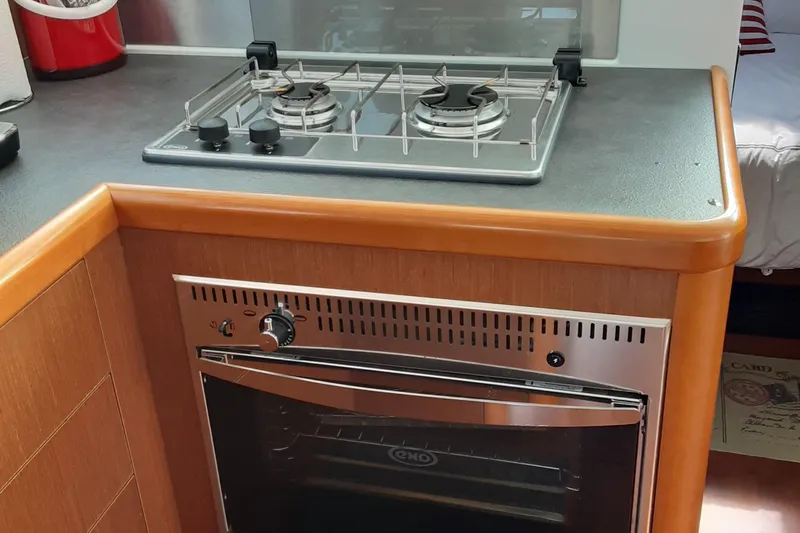  Yacht Photos Pics Compact kitchen with stove and oven in 2014 Beneteau Swift Trawler 34 yacht.