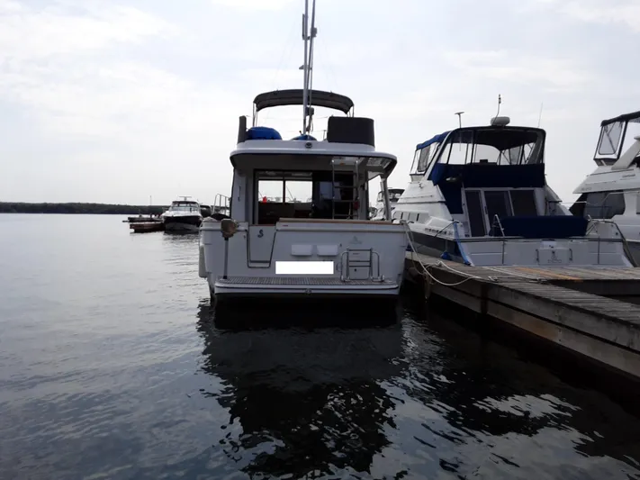  Yacht Photos Pics 2014 Beneteau Swift Trawler 34 docked at marina, rear view.