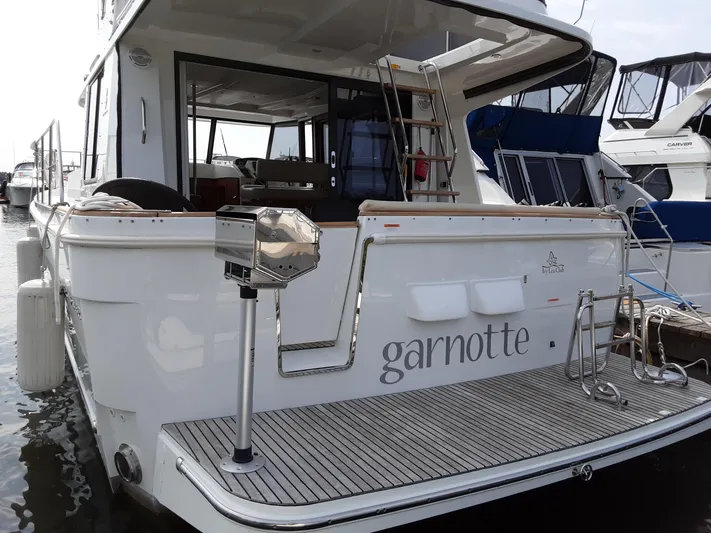  Yacht Photos Pics 2014 Beneteau Swift Trawler 34 docked, rear view with open deck and ladder.