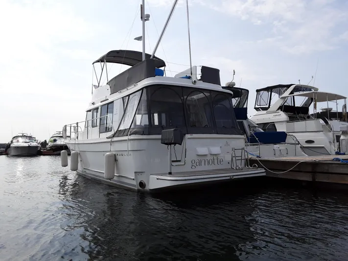  Yacht Photos Pics 2014 Beneteau Swift Trawler 34 docked at marina, overcast sky, calm water.