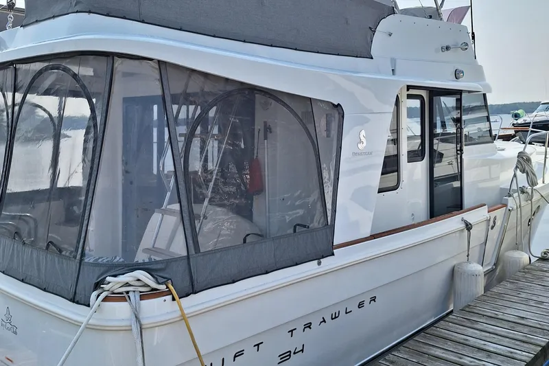  Yacht Photos Pics 2014 Beneteau Swift Trawler 34 docked, featuring enclosed cockpit and sleek design.