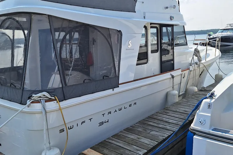  Yacht Photos Pics 2014 Beneteau Swift Trawler 34 docked, featuring enclosed cabin and sleek design.
