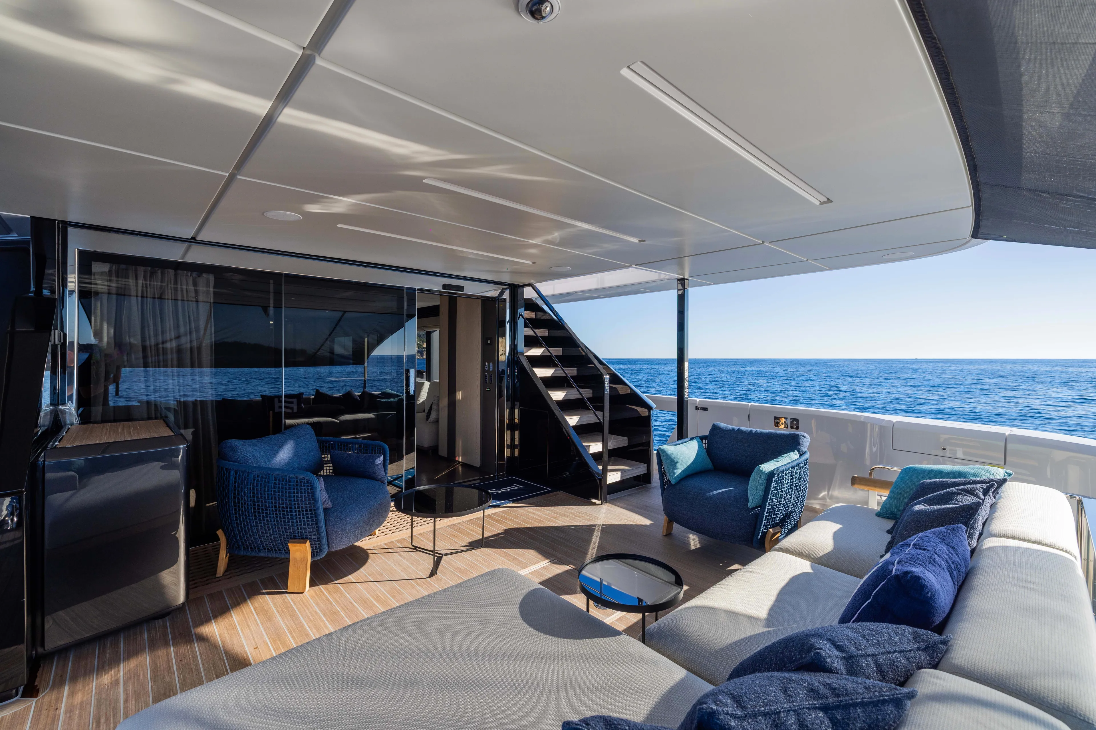  Yacht Photos Pics Luxurious 2025 Ferretti Yachts INFYNITO 80 deck with modern seating and ocean view.