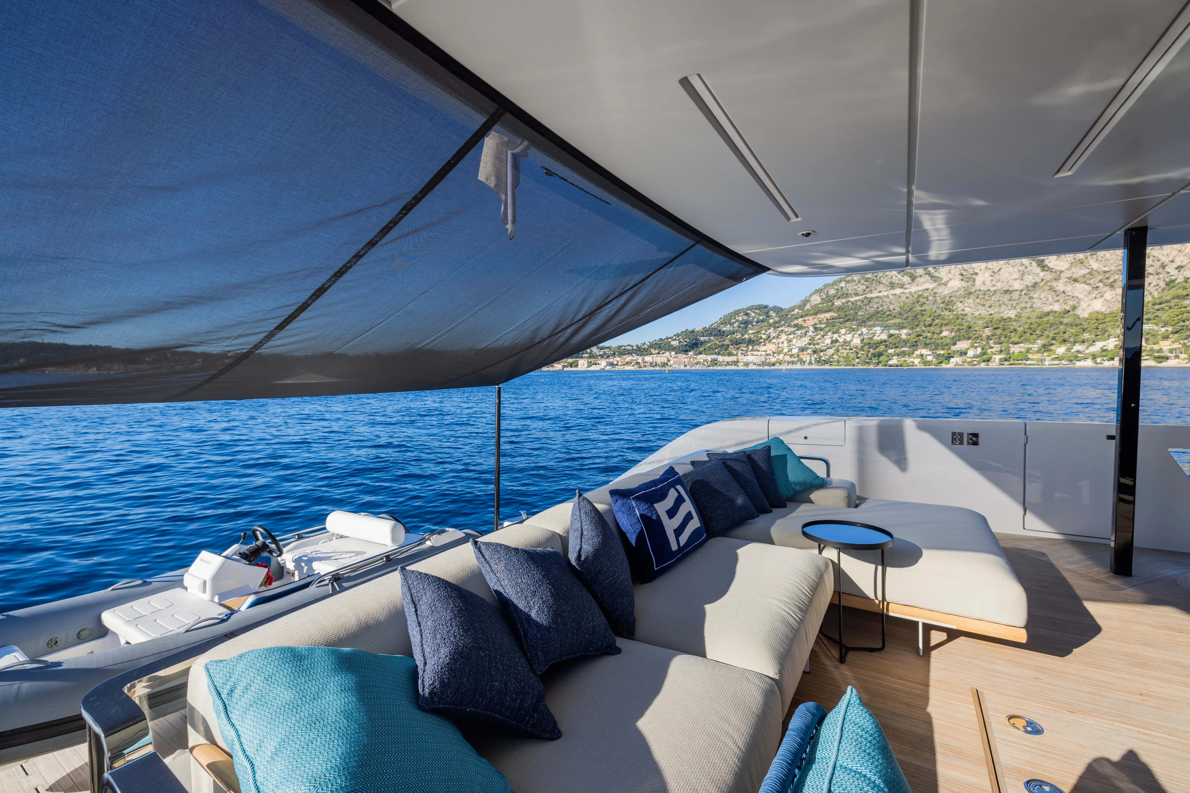  Yacht Photos Pics Luxurious 2025 Ferretti Yachts INFYNITO 80 deck with plush seating and ocean view.