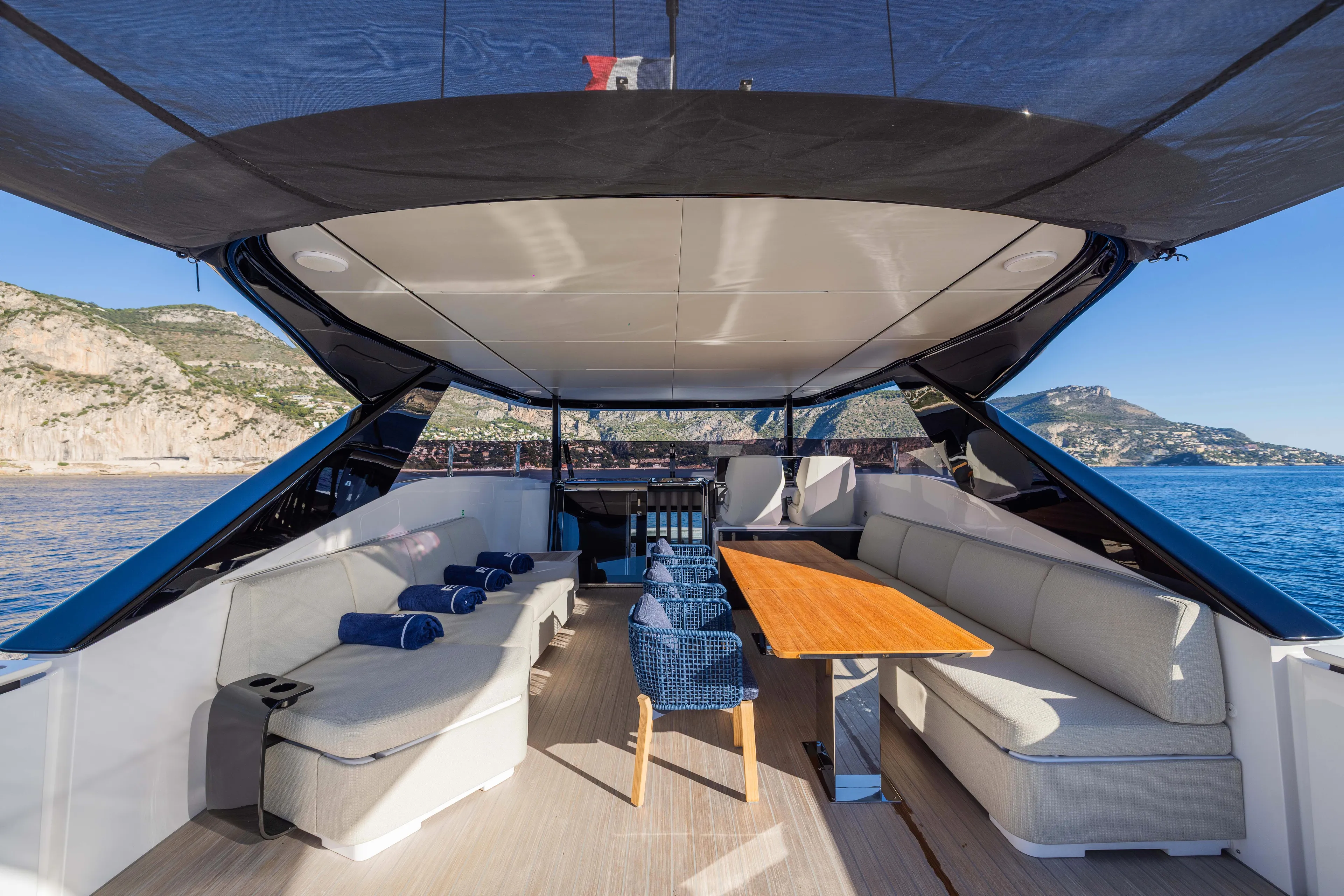  Yacht Photos Pics Luxurious 2025 Ferretti Yachts INFYNITO 80 deck with elegant seating and scenic ocean view.