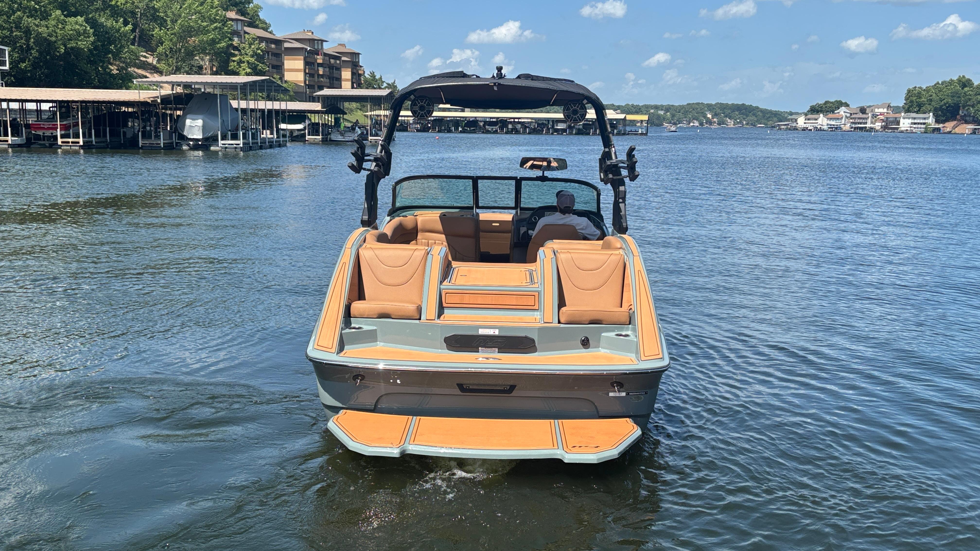 2025 MB B52 25 Alpha boat on a lake, featuring sleek design and spacious seating.