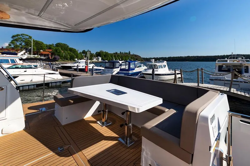 Dream Yacht Photos Pics Manufacturer Provided Image: Galeon 470 Sky 2019 yacht with outdoor seating area at a marina.