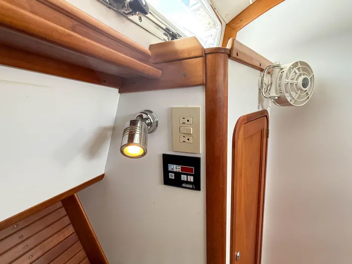 Waypoint Yacht Photos Pics Interior of 2002 Legacy 34 Express boat with wooden accents and lighting fixtures.