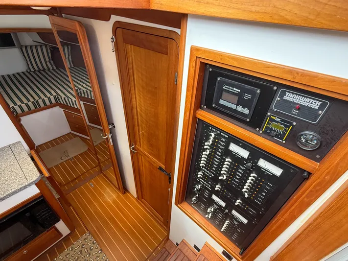 Waypoint Yacht Photos Pics Interior of 2002 Legacy 34 Express boat with control panel and wooden flooring.