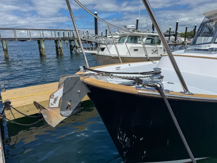 Waypoint Yacht Photos Pics 2002 Legacy 34 Express boat docked at marina with anchor visible.
