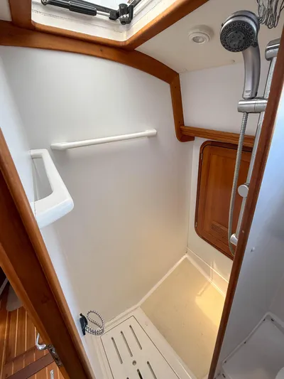 Waypoint Yacht Photos Pics 2002 Legacy 34 Express boat shower with wooden trim and handheld showerhead.