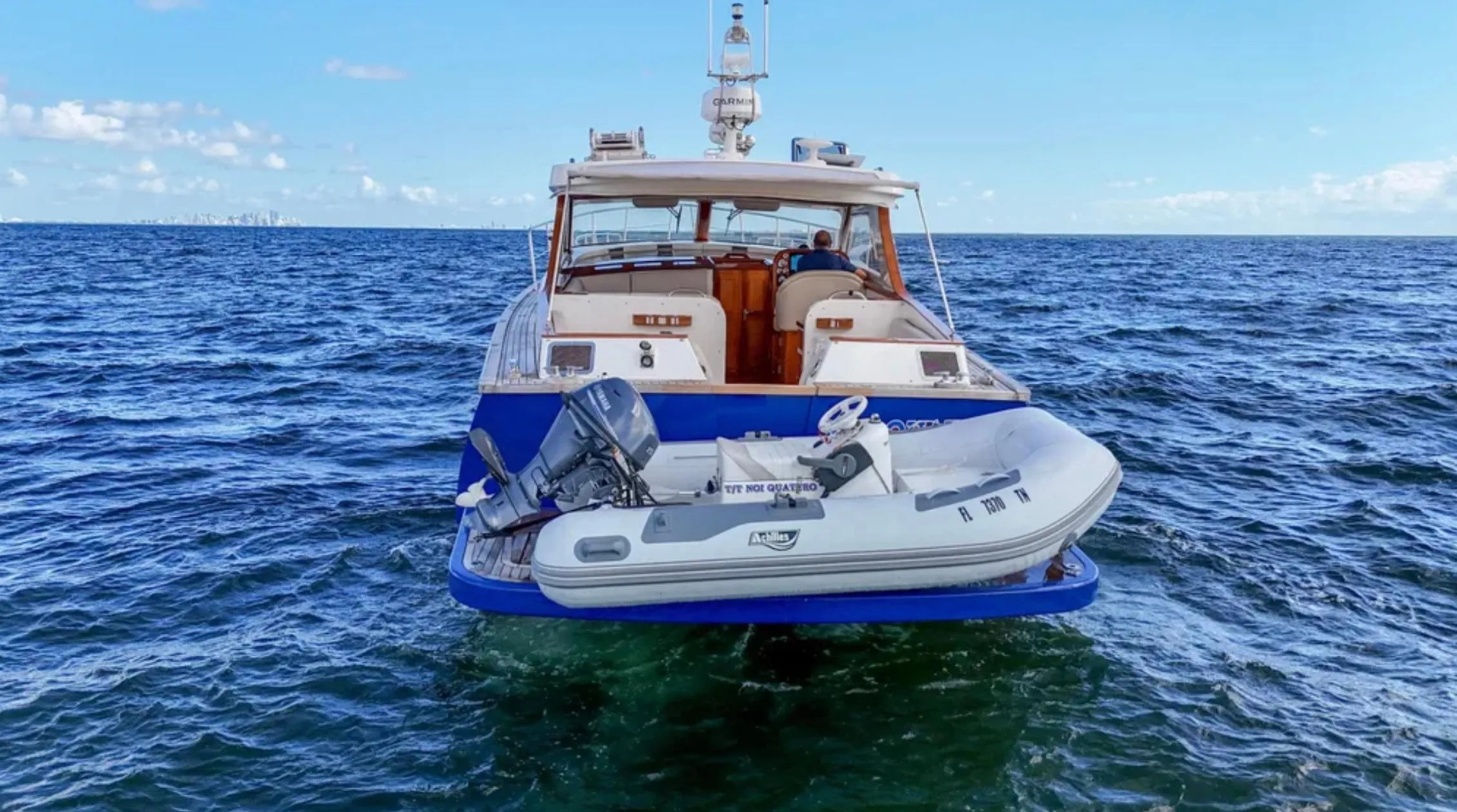 Custom 2010 Gentleman's Motor Yacht with dinghy on open sea.