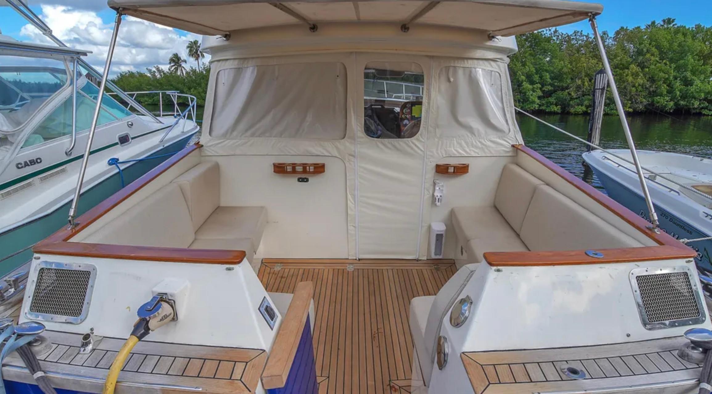 Luxurious 2010 Custom Gentleman's Motor Yacht with spacious seating and elegant wood finish.