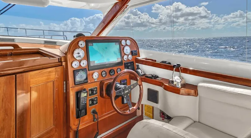 Noi Qauttro Yacht Photos Pics Luxurious yacht helm with wooden dashboard, ocean view, and navigation equipment.