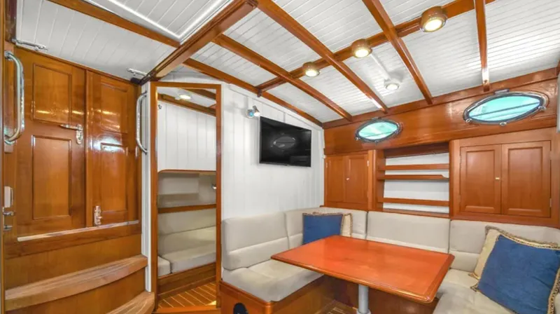 Noi Qauttro Yacht Photos Pics Luxurious interior of 2010 Custom Gentleman's Motor Yacht with wood paneling and cozy seating area.