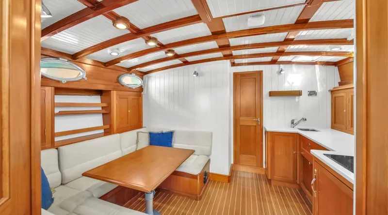 Noi Qauttro Yacht Photos Pics Luxurious interior of 2010 Custom Gentleman's Motor Yacht with wood finish and cozy seating area.