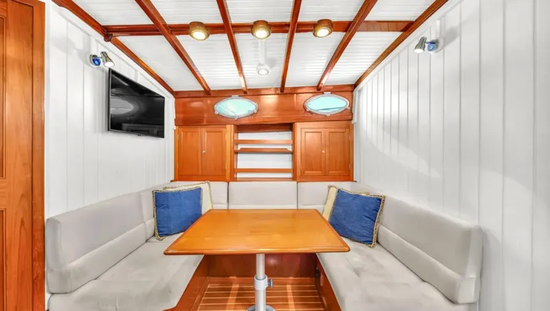 Noi Qauttro Yacht Photos Pics Luxurious interior of 2010 Custom Gentleman's Motor Yacht with elegant seating and wooden accents.