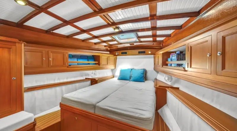 Noi Qauttro Yacht Photos Pics Luxurious cabin interior of 2010 Custom Gentleman's Motor Yacht with wooden finish and cozy bedding.