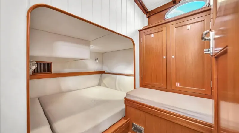 Noi Qauttro Yacht Photos Pics Luxurious cabin interior of 2010 Custom Gentleman's Motor Yacht with wooden finishes and cozy bed.