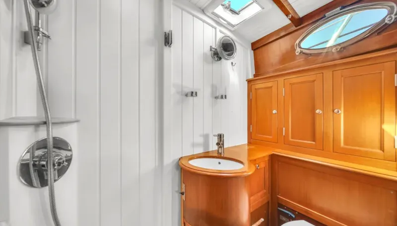 Noi Qauttro Yacht Photos Pics Luxurious yacht bathroom with wooden cabinets, modern fixtures, and skylight. Custom Gentlemans Motor Yacht, 2010.