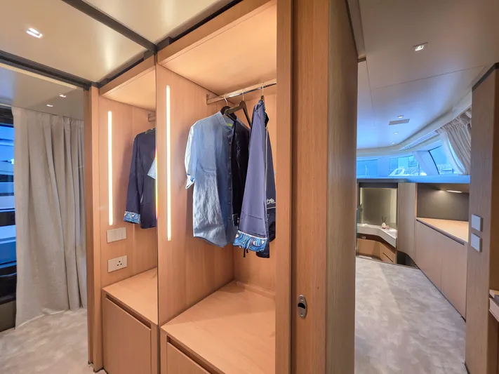  Yacht Photos Pics Luxurious interior of 2025 Sanlorenzo SD90 yacht with elegant wooden wardrobe and modern lighting.