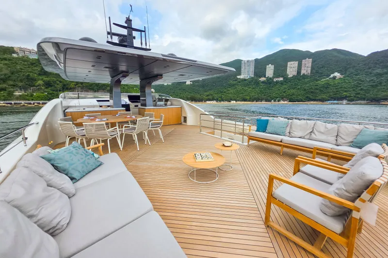  Yacht Photos Pics Luxurious 2025 Sanlorenzo SD90 yacht deck with elegant seating and scenic waterfront view.