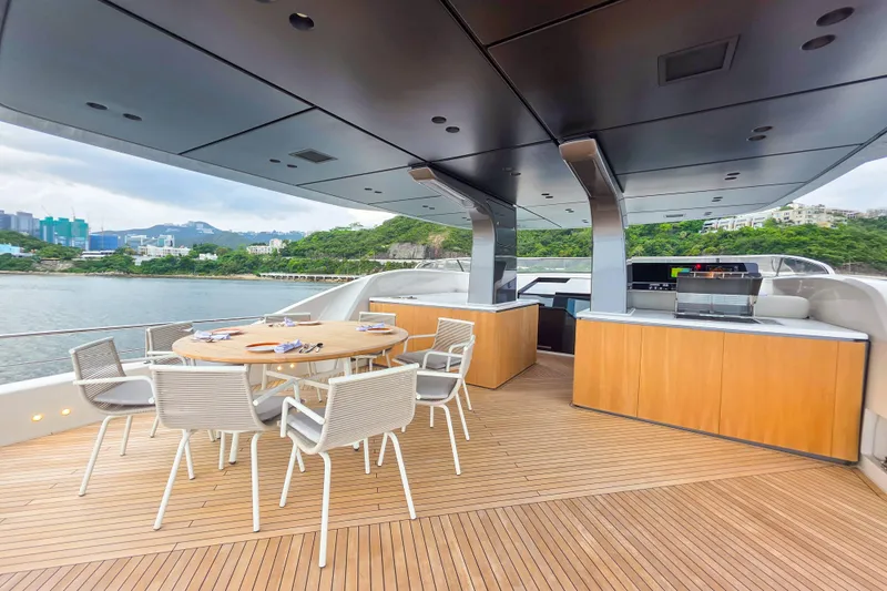  Yacht Photos Pics Luxurious 2025 Sanlorenzo SD90 yacht deck with dining area and scenic waterfront view.