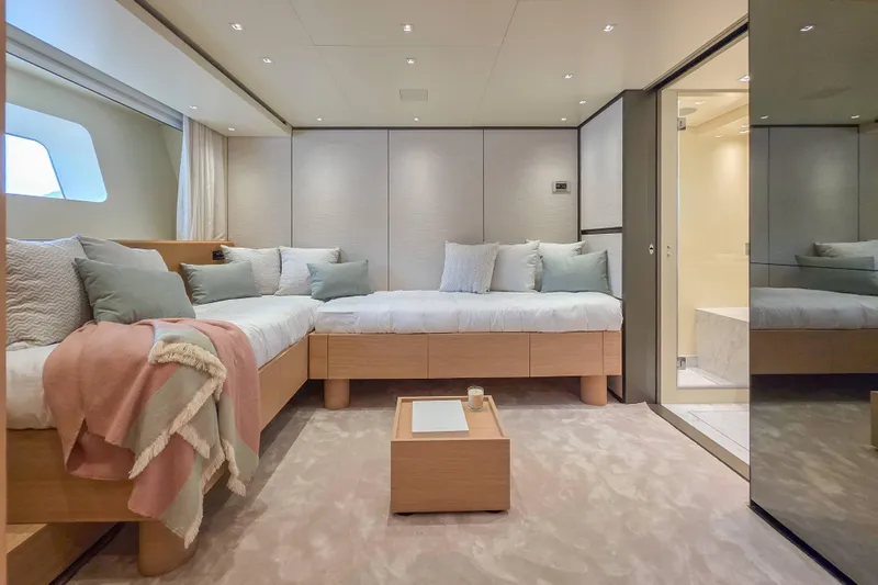  Yacht Photos Pics Luxurious 2025 Sanlorenzo SD90 yacht bedroom with modern decor and cozy bedding.