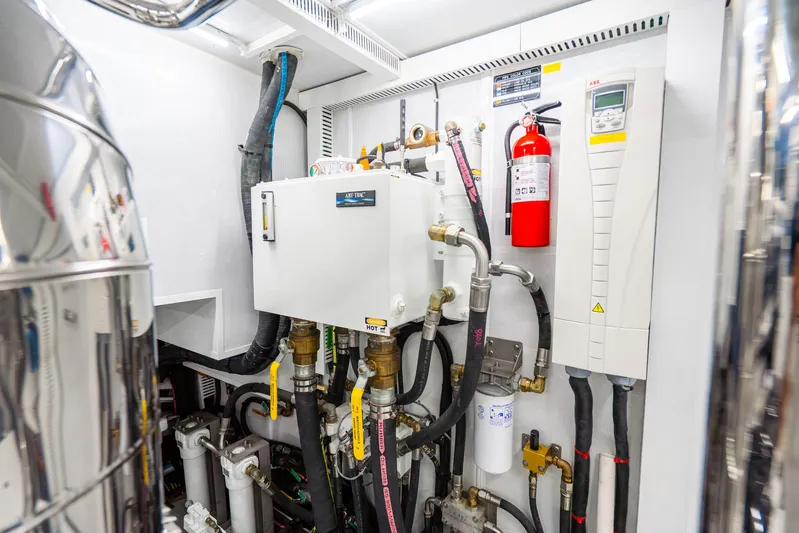 One More Time Yacht Photos Pics Engine room of 2020 Horizon FD80 yacht with control systems and fire extinguisher.