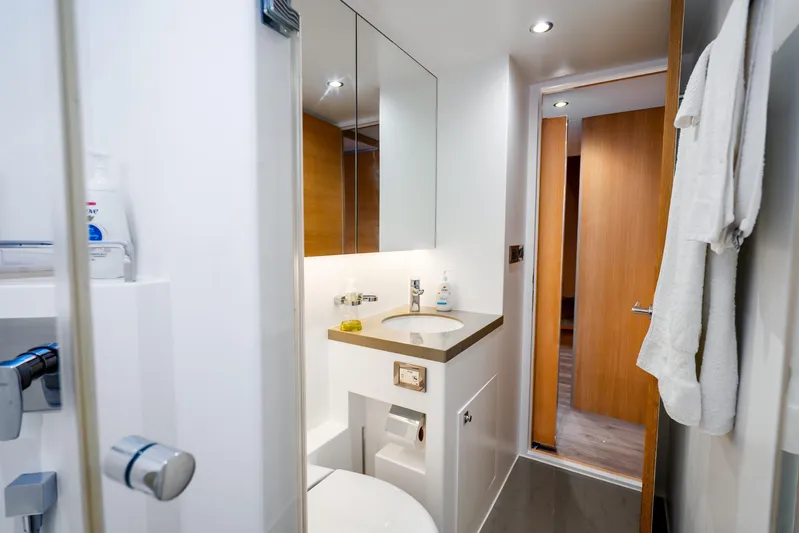 One More Time Yacht Photos Pics Modern bathroom interior on 2020 Horizon FD80 yacht, featuring sleek fixtures and wooden accents.