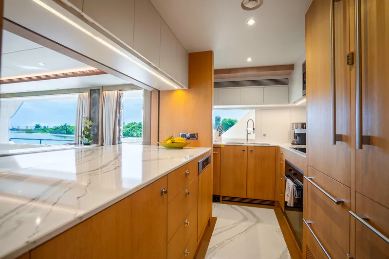 One More Time Yacht Photos Pics Luxurious Horizon FD80 yacht kitchen with modern wood cabinetry and marble countertops, 2020 model.