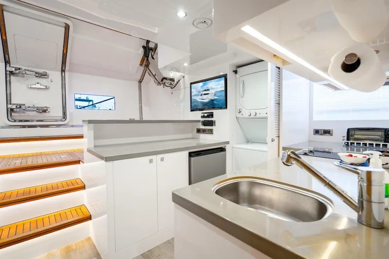 One More Time Yacht Photos Pics Modern yacht interior with kitchen, stairs, and appliances; Horizon FD80, 2020 model.