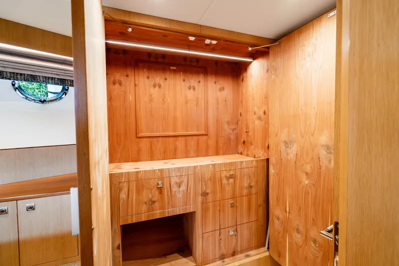 One More Time Yacht Photos Pics Luxurious wooden interior of 2020 Horizon FD80 yacht cabin with built-in storage.