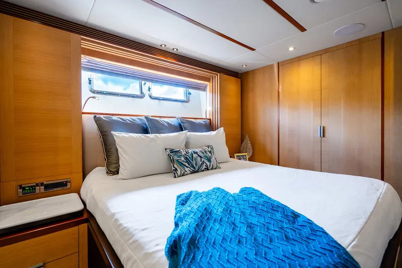 One More Time Yacht Photos Pics Luxurious bedroom interior on 2020 Horizon FD80 yacht with modern wood paneling.