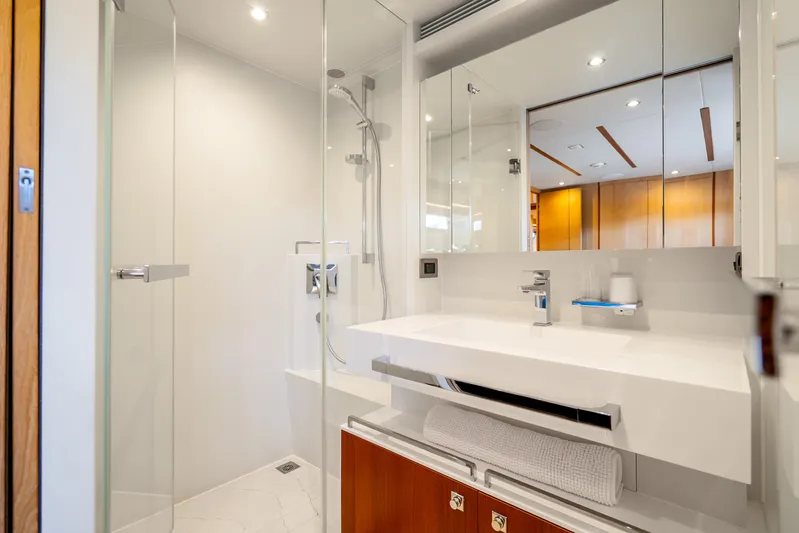 One More Time Yacht Photos Pics Modern bathroom on 2020 Horizon FD80 yacht with sleek fixtures and glass shower.