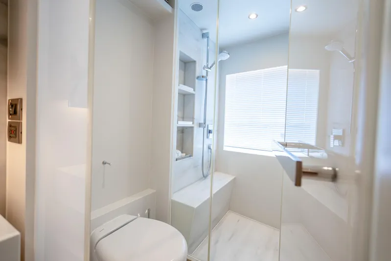 One More Time Yacht Photos Pics Modern bathroom interior on Horizon FD80 yacht, 2020 model, featuring sleek design and natural lighting.