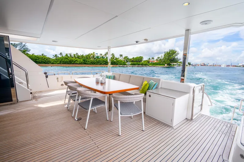 One More Time Yacht Photos Pics Luxurious Horizon FD80 yacht deck with dining area, ocean view, and modern seating, 2020 model.