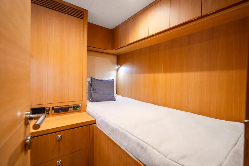 One More Time Yacht Photos Pics Cozy cabin interior of 2020 Horizon FD80 yacht with wooden finish and single bed.