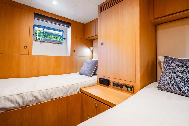 One More Time Yacht Photos Pics Luxurious cabin interior of 2020 Horizon FD80 yacht with twin beds and wooden finish.