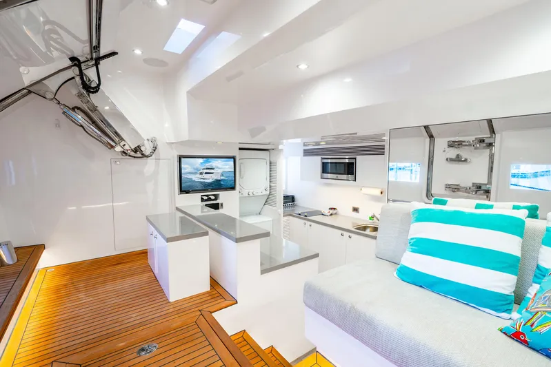 One More Time Yacht Photos Pics Luxurious 2020 Horizon FD80 yacht interior with modern kitchen and cozy seating area.