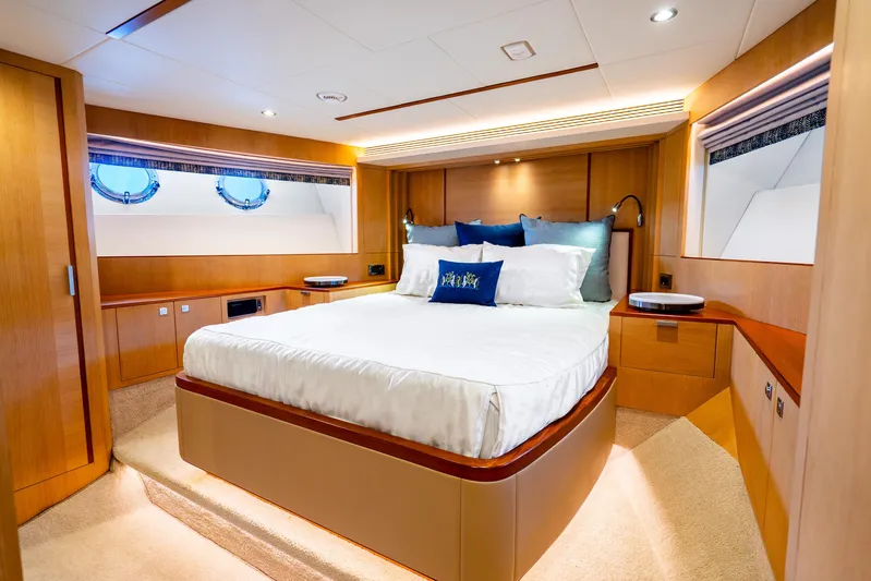 One More Time Yacht Photos Pics Luxurious bedroom interior on 2020 Horizon FD80 yacht with elegant wood finishes.