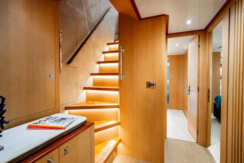 One More Time Yacht Photos Pics Luxurious interior of 2020 Horizon FD80 yacht with illuminated wooden staircase.